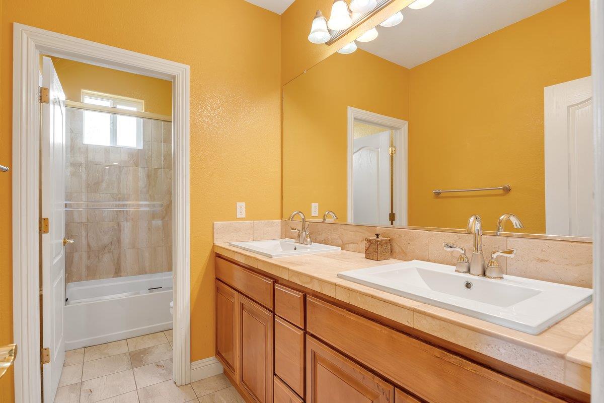 33 Aurora Lane Copperopolis, CA 95228 - Photo 36 of 46 full bath featuring double vanity, combined bath / shower with glass door, and light tile patterned floors