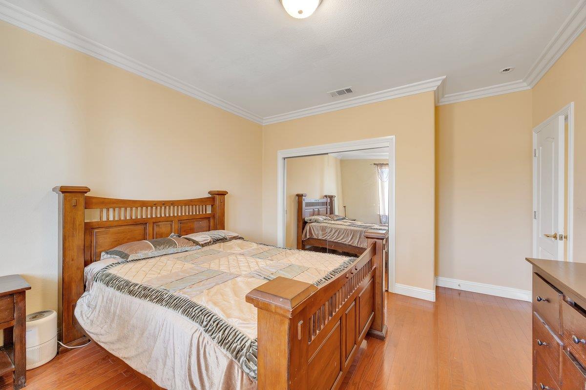 33 Aurora Lane Copperopolis, CA 95228 - Photo 38 of 46 bedroom with light wood-type flooring, crown molding, and a closet