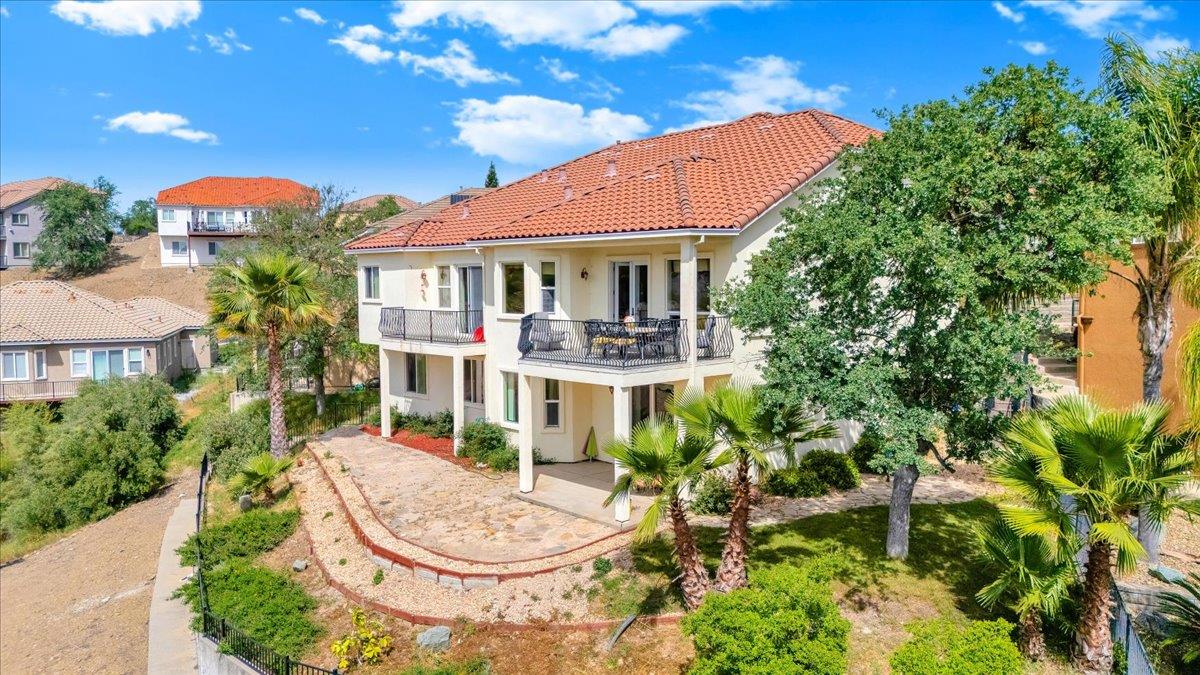33 Aurora Lane Copperopolis, CA 95228 - Photo 4 of 46 rear view of house with stucco siding, a balcony, and a tiled roof