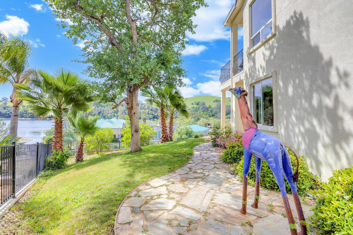33 Aurora Lane Copperopolis, CA 95228 - Photo 40 of 46 fenced backyard featuring a balcony and a patio with a view of Lake Tulloch