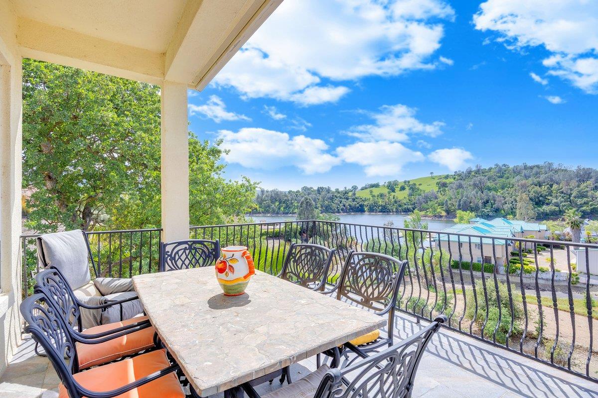 33 Aurora Lane Copperopolis, CA 95228 - Photo 41 of 46 balcony featuring outdoor dining space, a lake view, and views of the hills