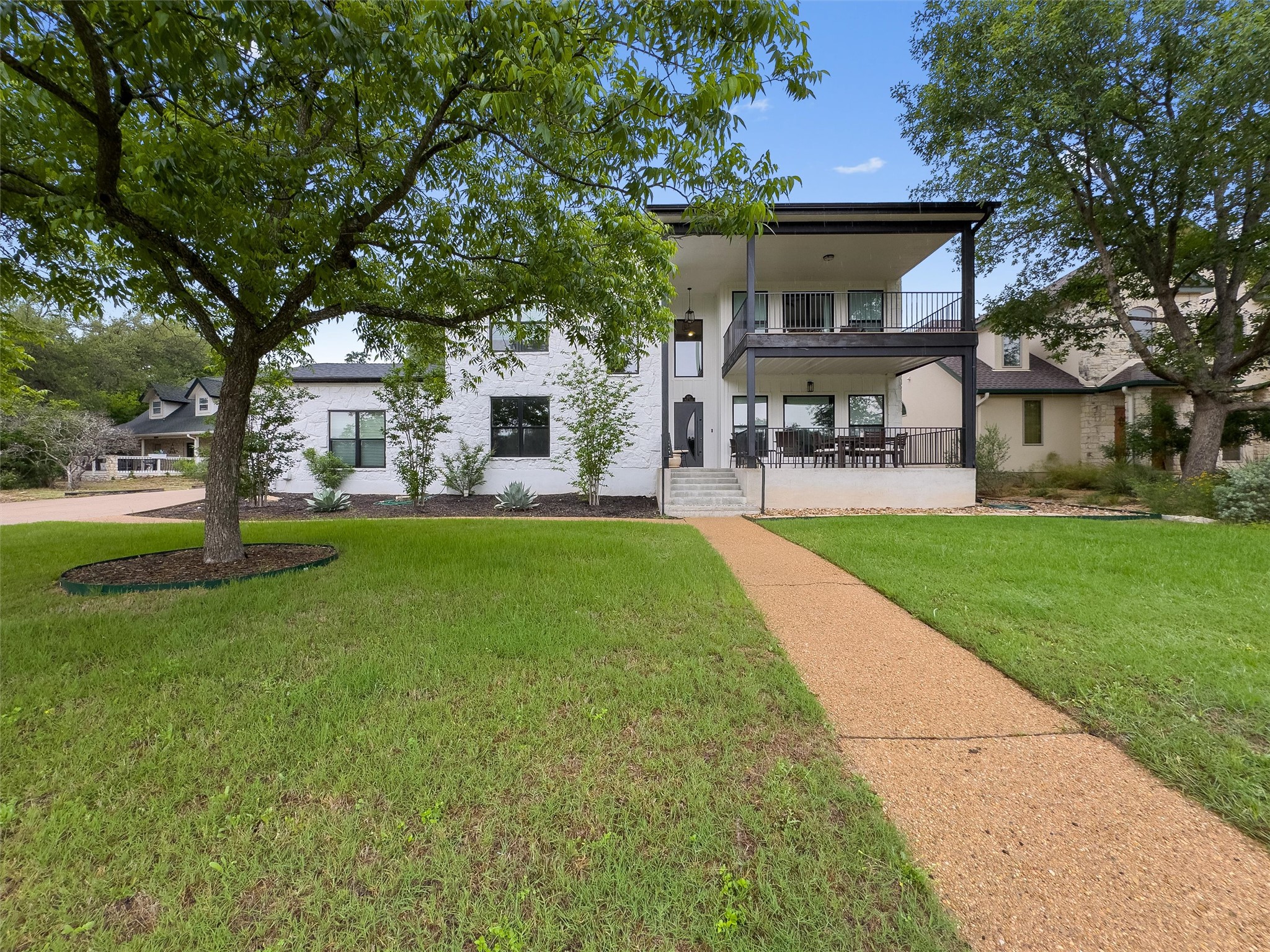307 Hurst Creek Road Austin, TX 78734 - Photo 1 of 40 Two-story residence featuring a white brick facade and dark trim accents