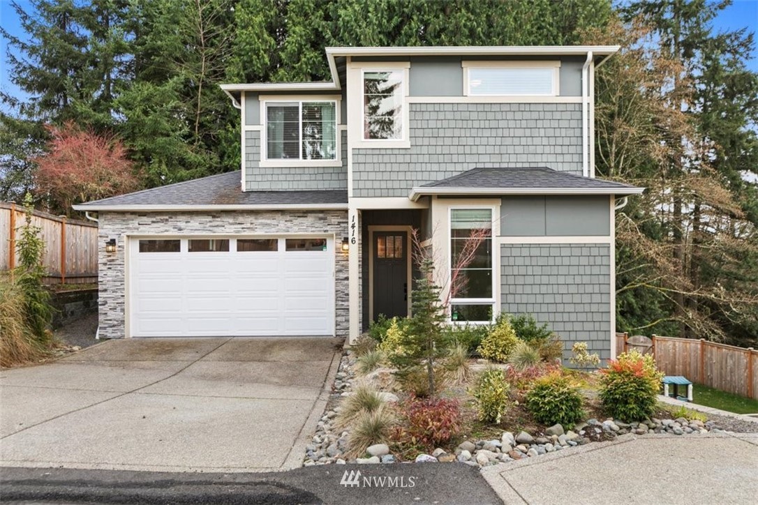 1416 242nd Place Southeast Bothell, WA 98021 - Photo 1 of 39 a front view of a house with a garden