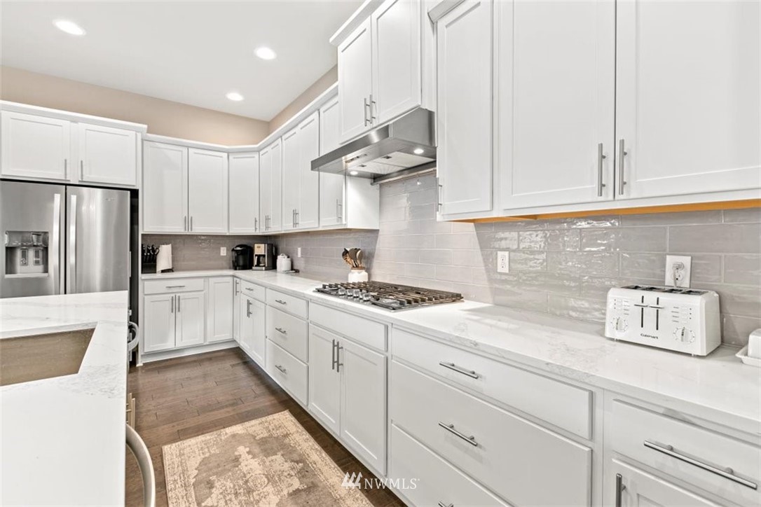 1416 242nd Place Southeast Bothell, WA 98021 - Photo 13 of 39 a kitchen with stainless steel appliances granite countertop a sink a stove and a refrigerator