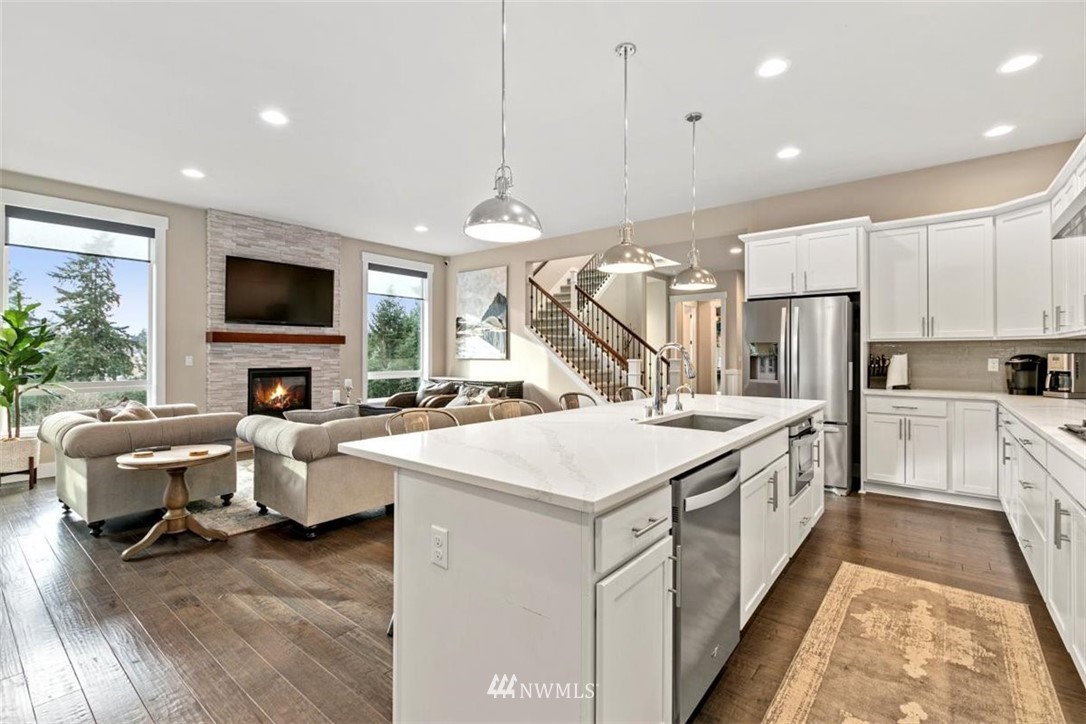 1416 242nd Place Southeast Bothell, WA 98021 - Photo 14 of 39 a kitchen that has a lot of white cabinets and stainless steel appliances
