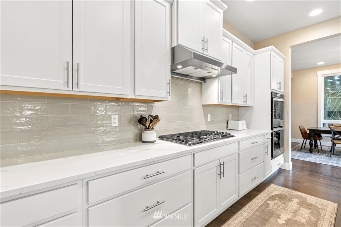 1416 242nd Place Southeast Bothell, WA 98021 - Photo 16 of 39 a kitchen with stainless steel appliances granite countertop a sink a stove and cabinets