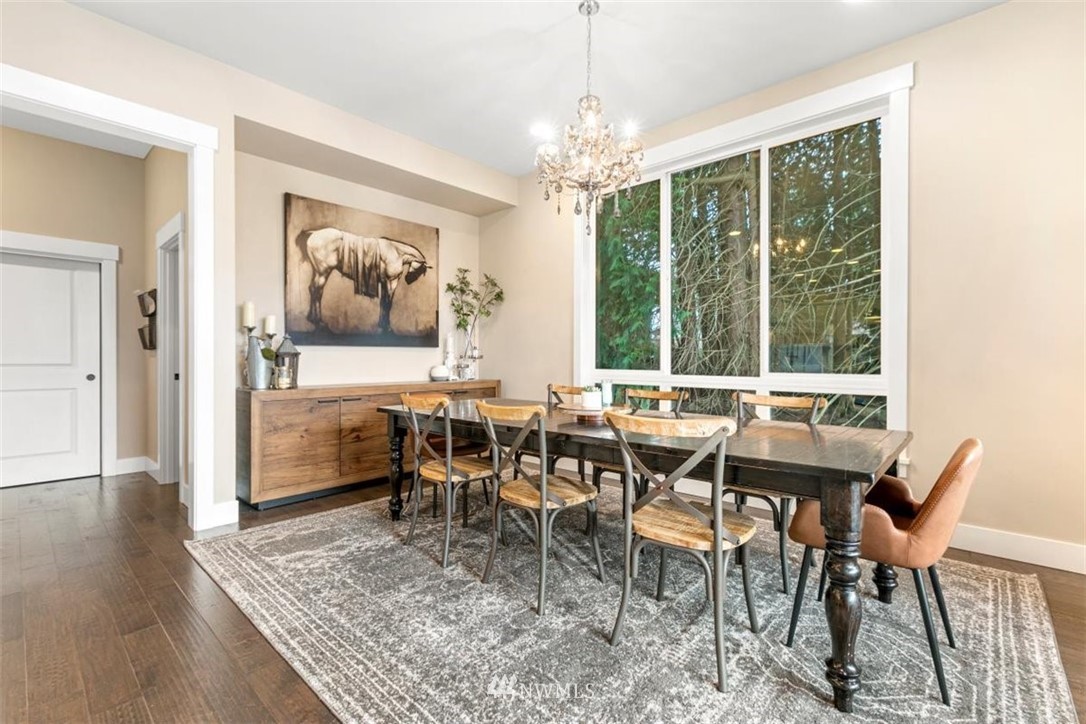 1416 242nd Place Southeast Bothell, WA 98021 - Photo 19 of 39 a view of a dining room with furniture wooden floor and chandelier