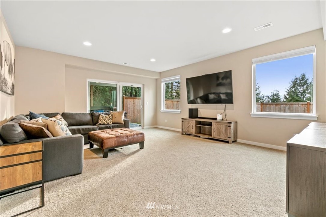 1416 242nd Place Southeast Bothell, WA 98021 - Photo 23 of 39 a living room with furniture and a flat screen tv