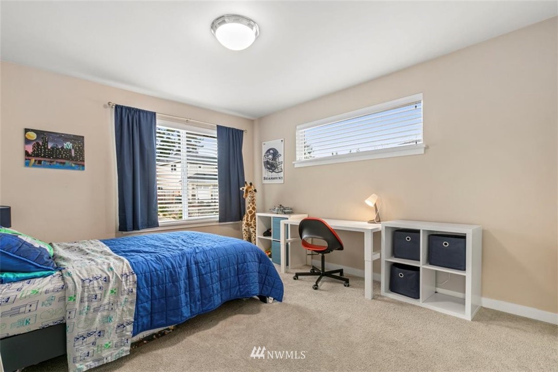 1416 242nd Place Southeast Bothell, WA 98021 - Photo 27 of 39 a bedroom with a bed and a chair