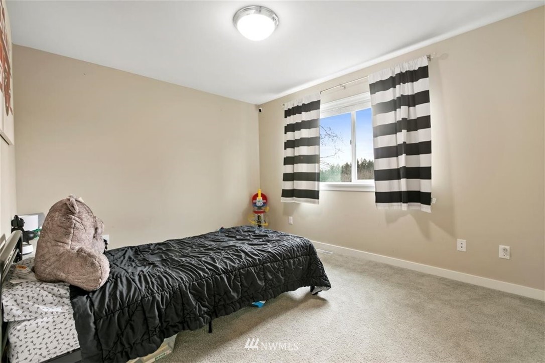 1416 242nd Place Southeast Bothell, WA 98021 - Photo 29 of 39 a bedroom with a bed and a window
