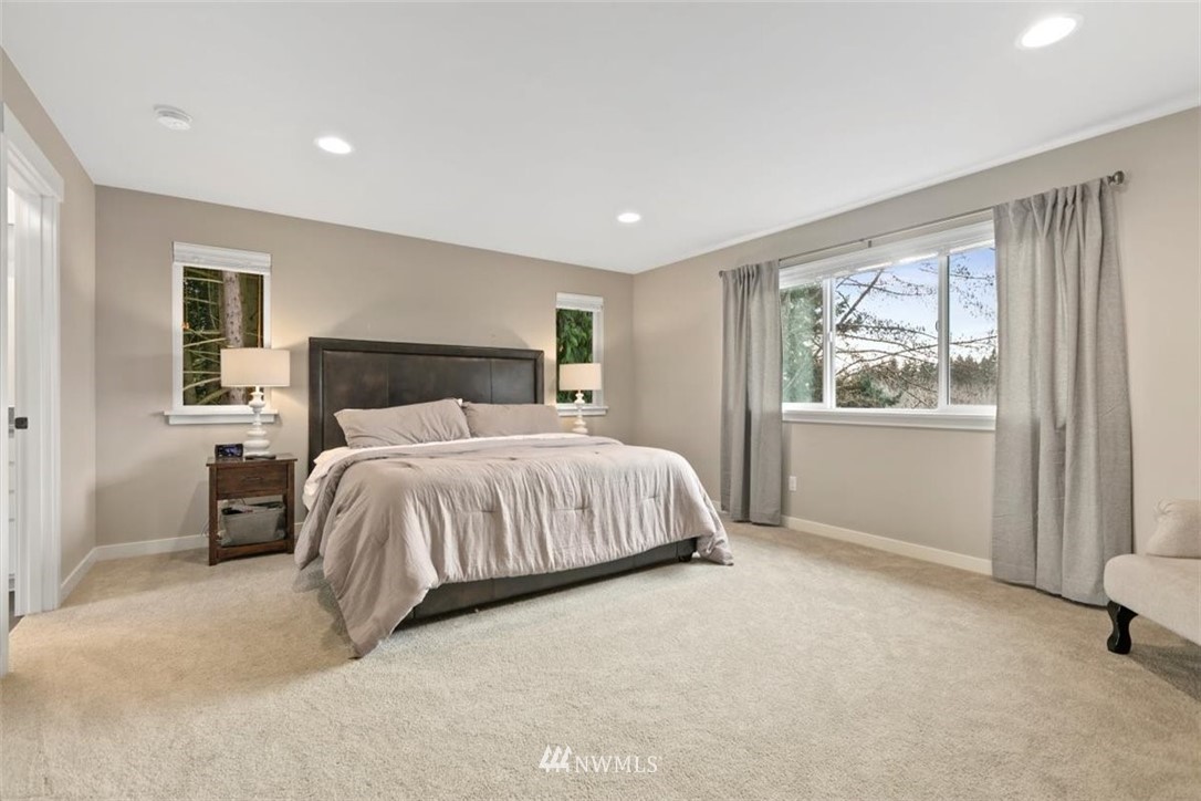 1416 242nd Place Southeast Bothell, WA 98021 - Photo 30 of 39 a bedroom with a large bed and a window