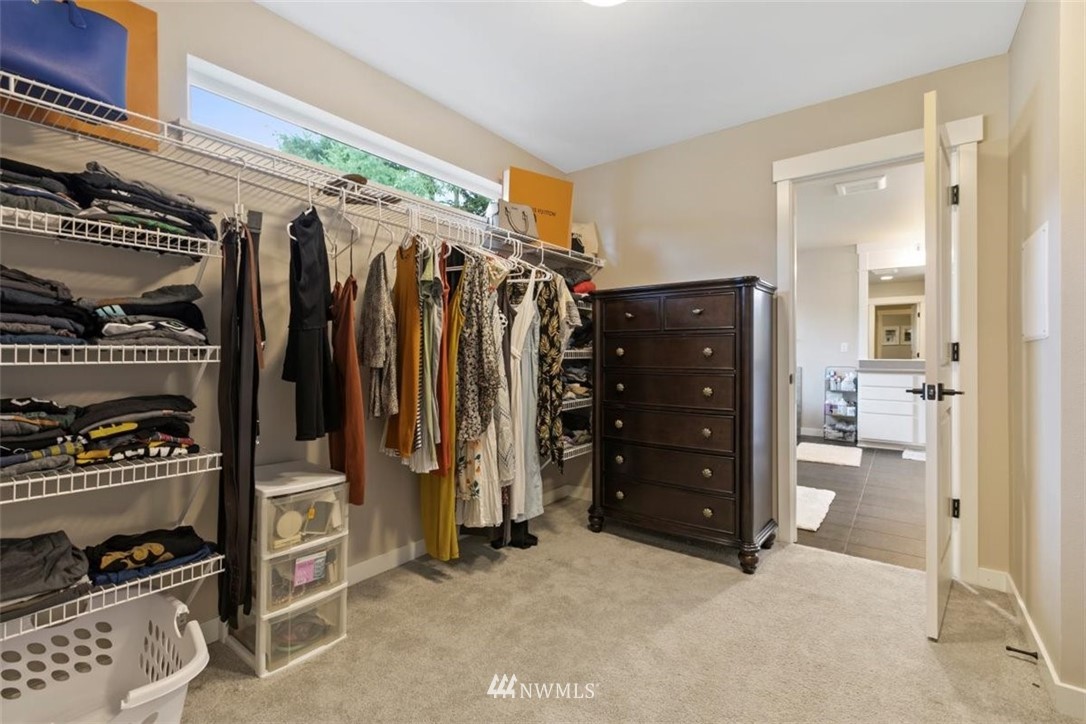 1416 242nd Place Southeast Bothell, WA 98021 - Photo 32 of 39 a view of walk in closet with clothes and shoes