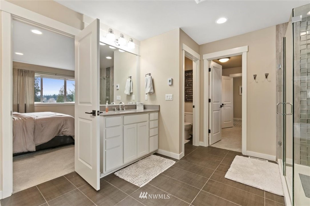 1416 242nd Place Southeast Bothell, WA 98021 - Photo 34 of 39 a bathroom with a double vanity sink mirror and shower