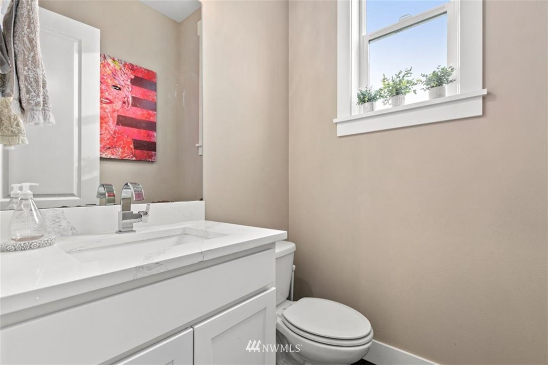 1416 242nd Place Southeast Bothell, WA 98021 - Photo 35 of 39 a bathroom with a sink mirror vanity and toilet