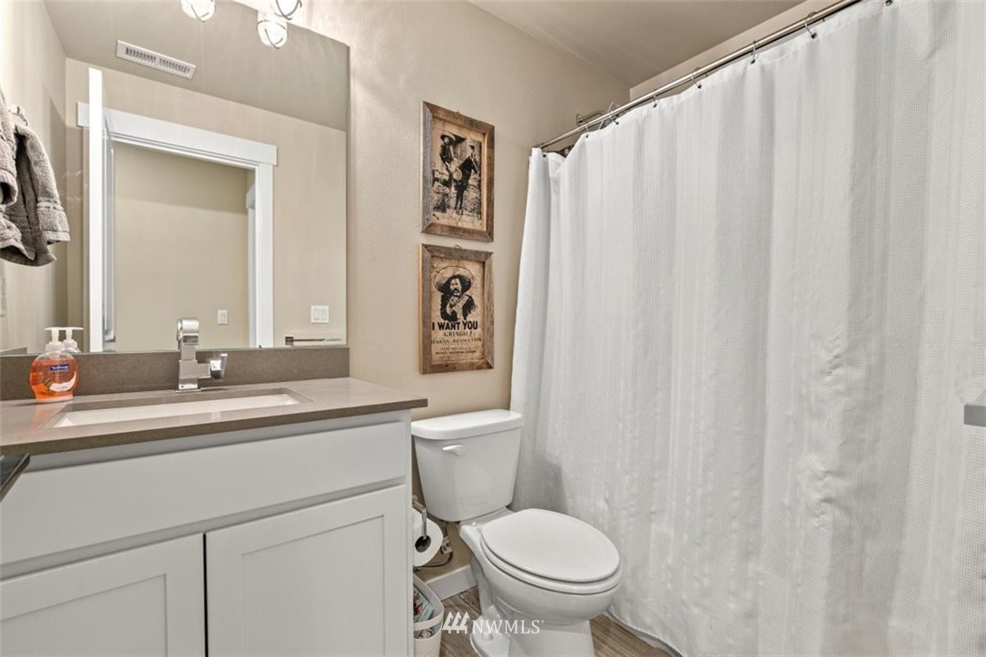 1416 242nd Place Southeast Bothell, WA 98021 - Photo 36 of 39 a bathroom with a toilet a sink and a mirror