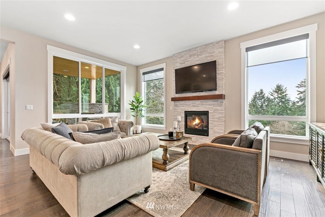 1416 242nd Place Southeast Bothell, WA 98021 - Photo 5 of 39 a living room with furniture and a fireplace