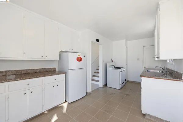 a kitchen with a sink a stove and refrigerator