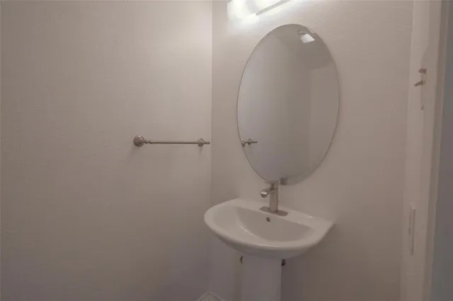 a bathroom with a sink and mirror