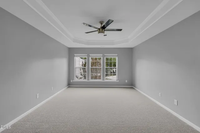 a view of a livingroom with a ceiling fan and window