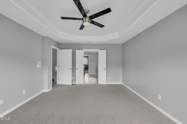 a view of empty room with ceiling fan