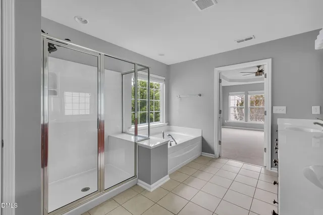 a spacious bathroom with a bathtub and a shower