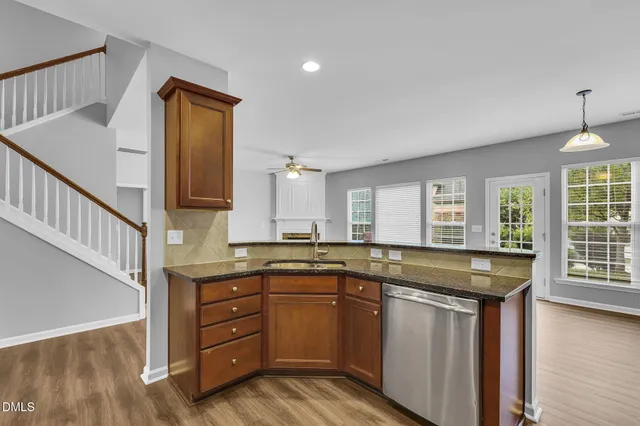a kitchen with a sink stove and cabinets