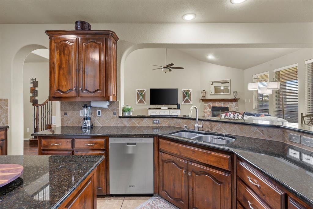 4172 Drexmore Road Fort Worth, TX 76244 - Photo 36 of 37 a kitchen with stainless steel appliances granite countertop a sink a stove and cabinets