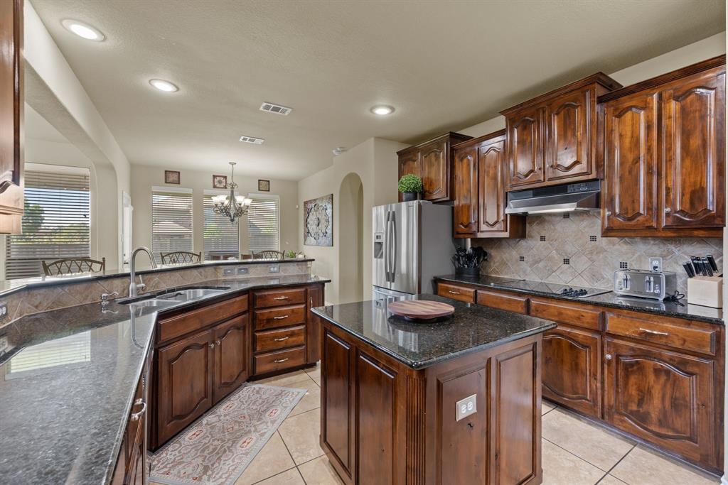 4172 Drexmore Road Fort Worth, TX 76244 - Photo 12 of 37 a kitchen with stainless steel appliances granite countertop a sink stove and refrigerator