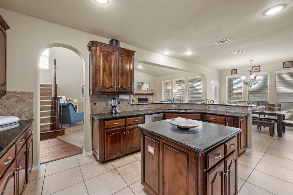4172 Drexmore Road Fort Worth, TX 76244 - Photo 14 of 37 a kitchen that has a sink a stove and chairs
