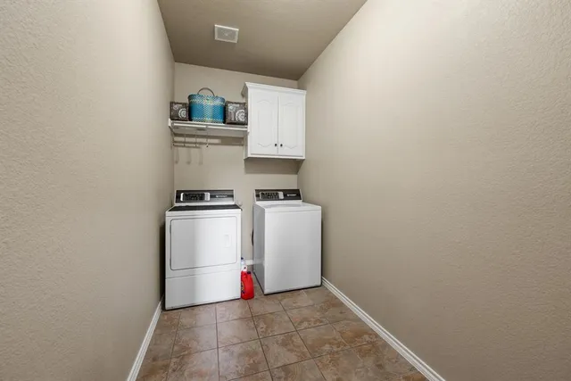 a kitchen that has a sink a stove and chairs