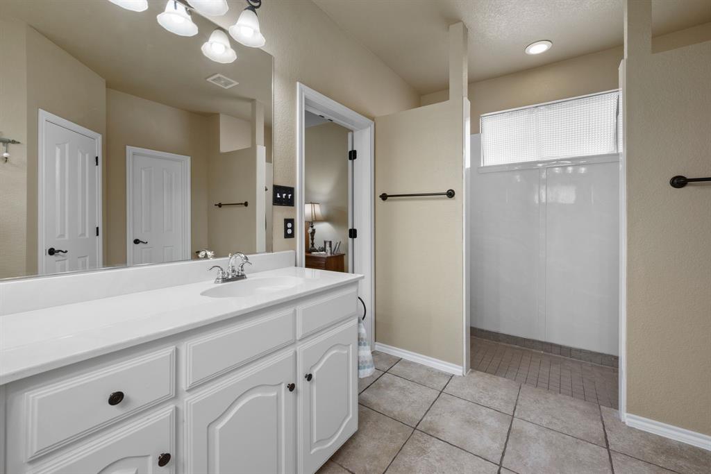 4172 Drexmore Road Fort Worth, TX 76244 - Photo 19 of 37 a bathroom with a sink and a mirror