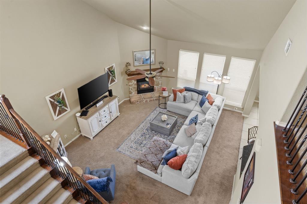 4172 Drexmore Road Fort Worth, TX 76244 - Photo 22 of 37 a living room with furniture a flat screen tv and a refrigerator
