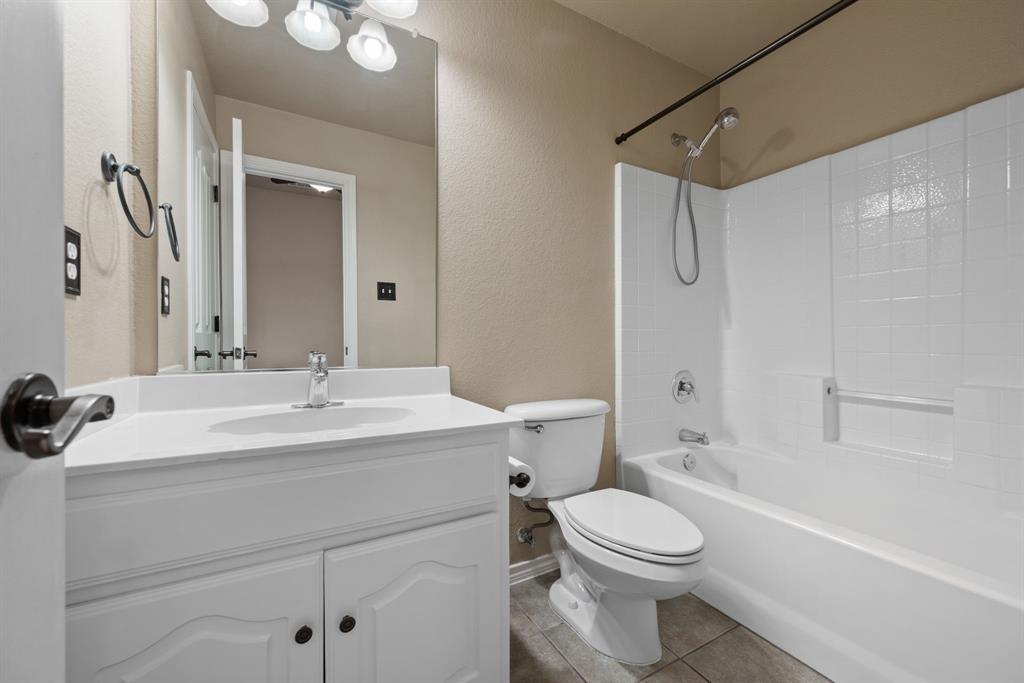 4172 Drexmore Road Fort Worth, TX 76244 - Photo 26 of 37 a bathroom with a toilet a sink and mirror