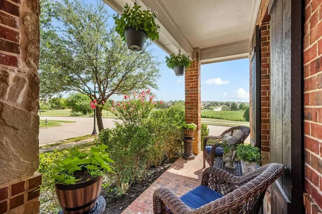 a view of a porch with furniture and garden