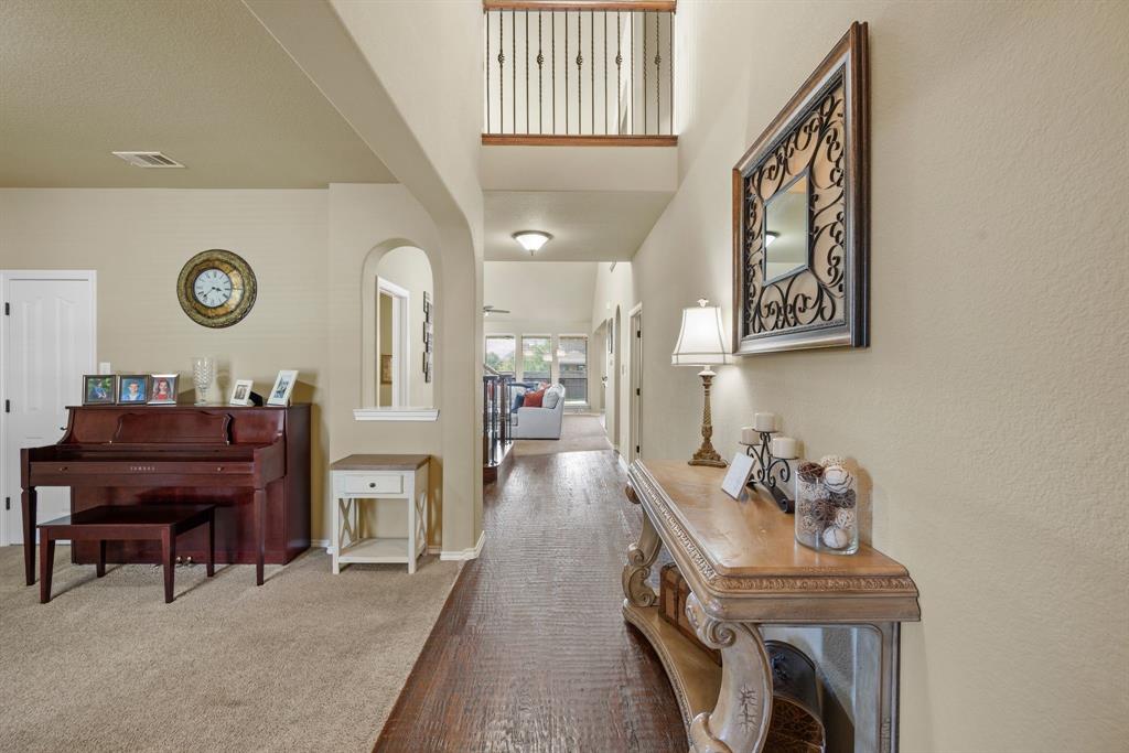 4172 Drexmore Road Fort Worth, TX 76244 - Photo 6 of 37 a living room with furniture and a clock