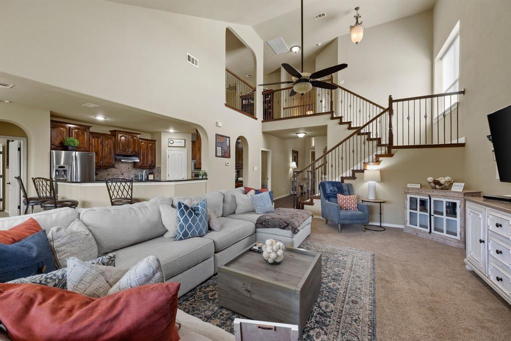 4172 Drexmore Road Fort Worth, TX 76244 - Photo 7 of 37 a living room with furniture ceiling fan and a rug