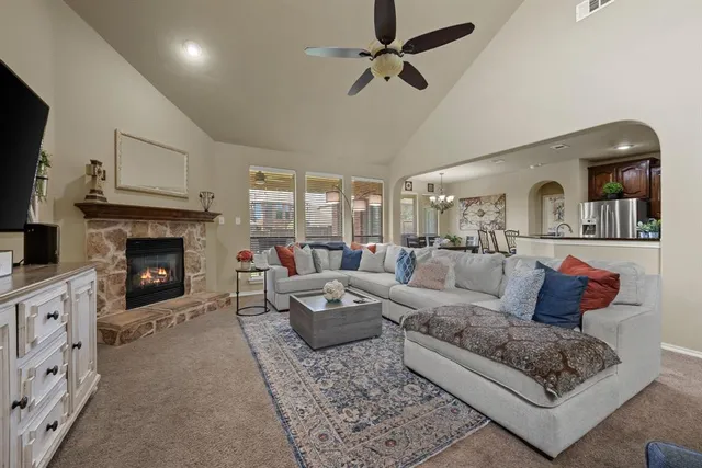 a living room with furniture a fireplace and a flat screen tv