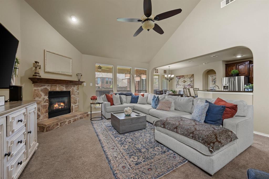4172 Drexmore Road Fort Worth, TX 76244 - Photo 8 of 37 a living room with furniture a fireplace and a flat screen tv