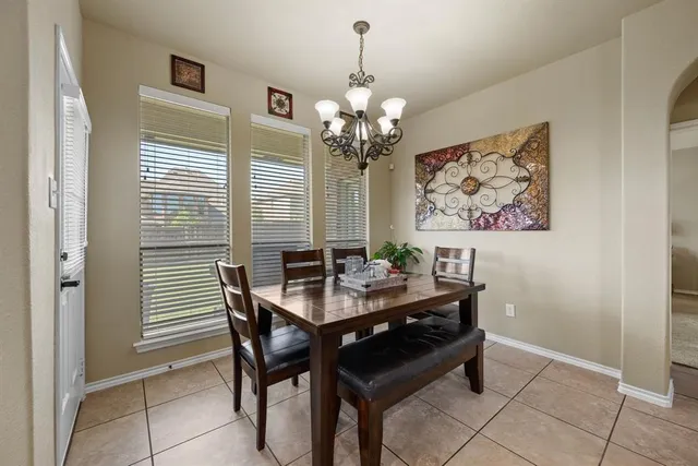 a dining room with furniture and a chandelier