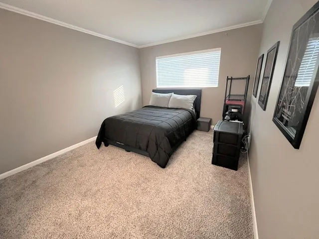 a bedroom with a bed a couch and dresser