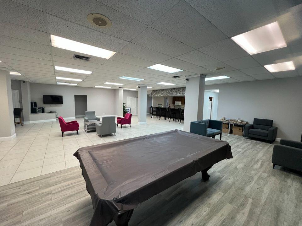 2920 Southwest 22nd Avenue, Unit 6040 Delray Beach, FL 33445 - Photo 16 of 53 a living room with furniture and a flat screen tv