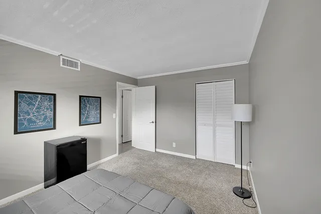 a bedroom with a bed and a night lamp