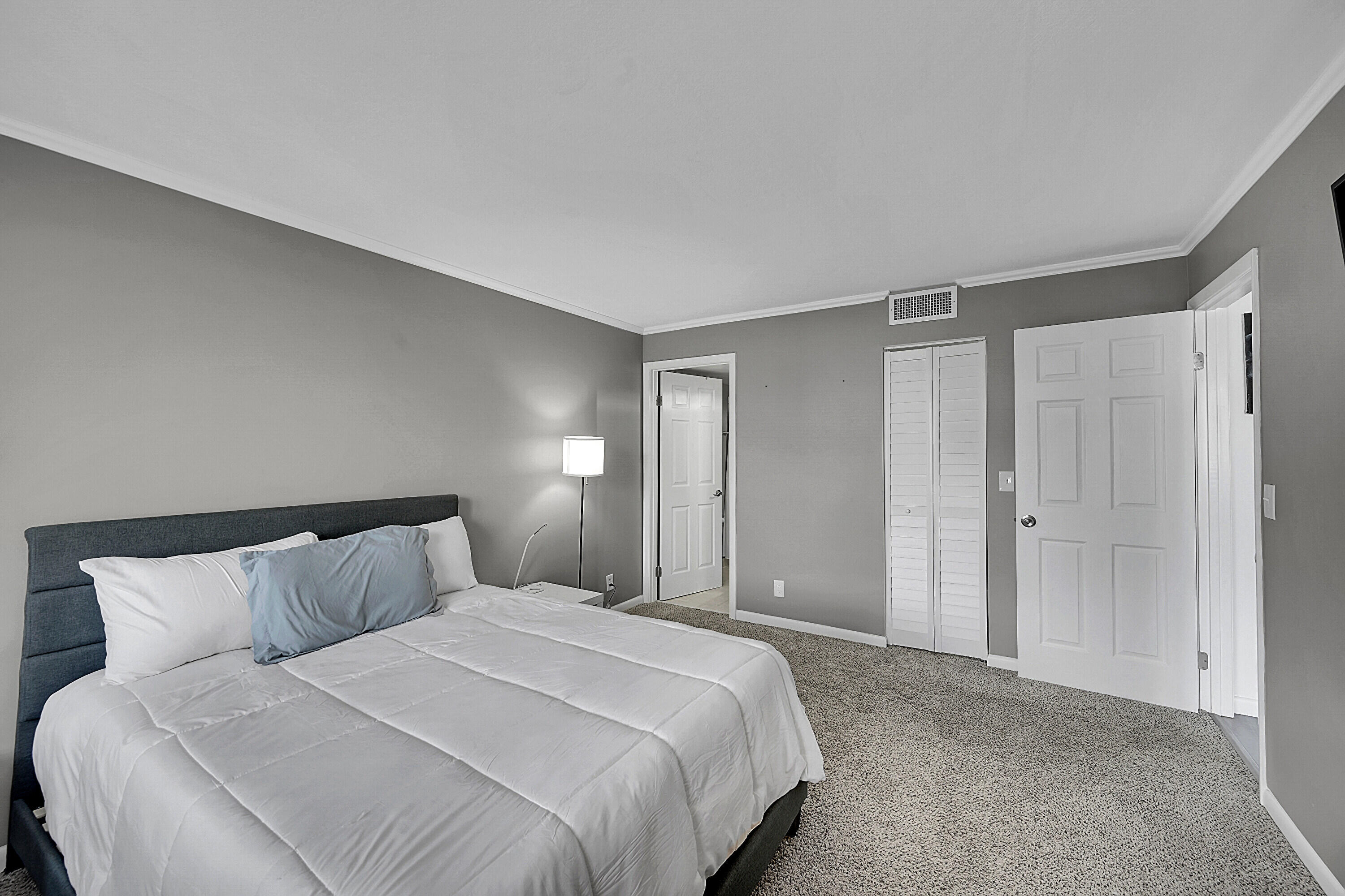 2920 Southwest 22nd Avenue, Unit 6040 Delray Beach, FL 33445 - Photo 22 of 53 a bedroom with a bed and a night lamp