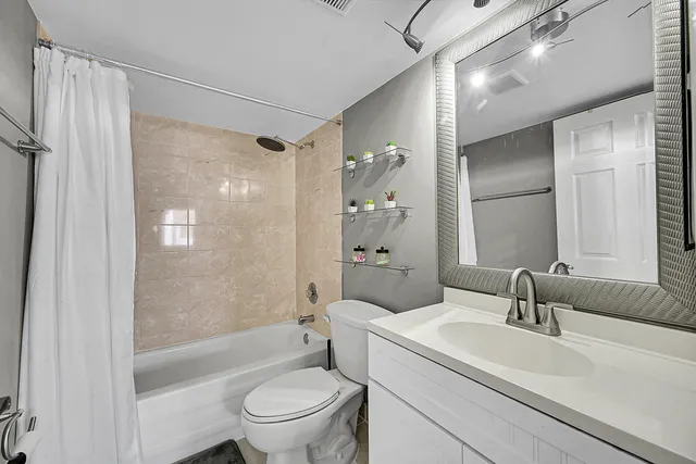 a kitchen with granite countertop a sink stainless steel appliances and white cabinets