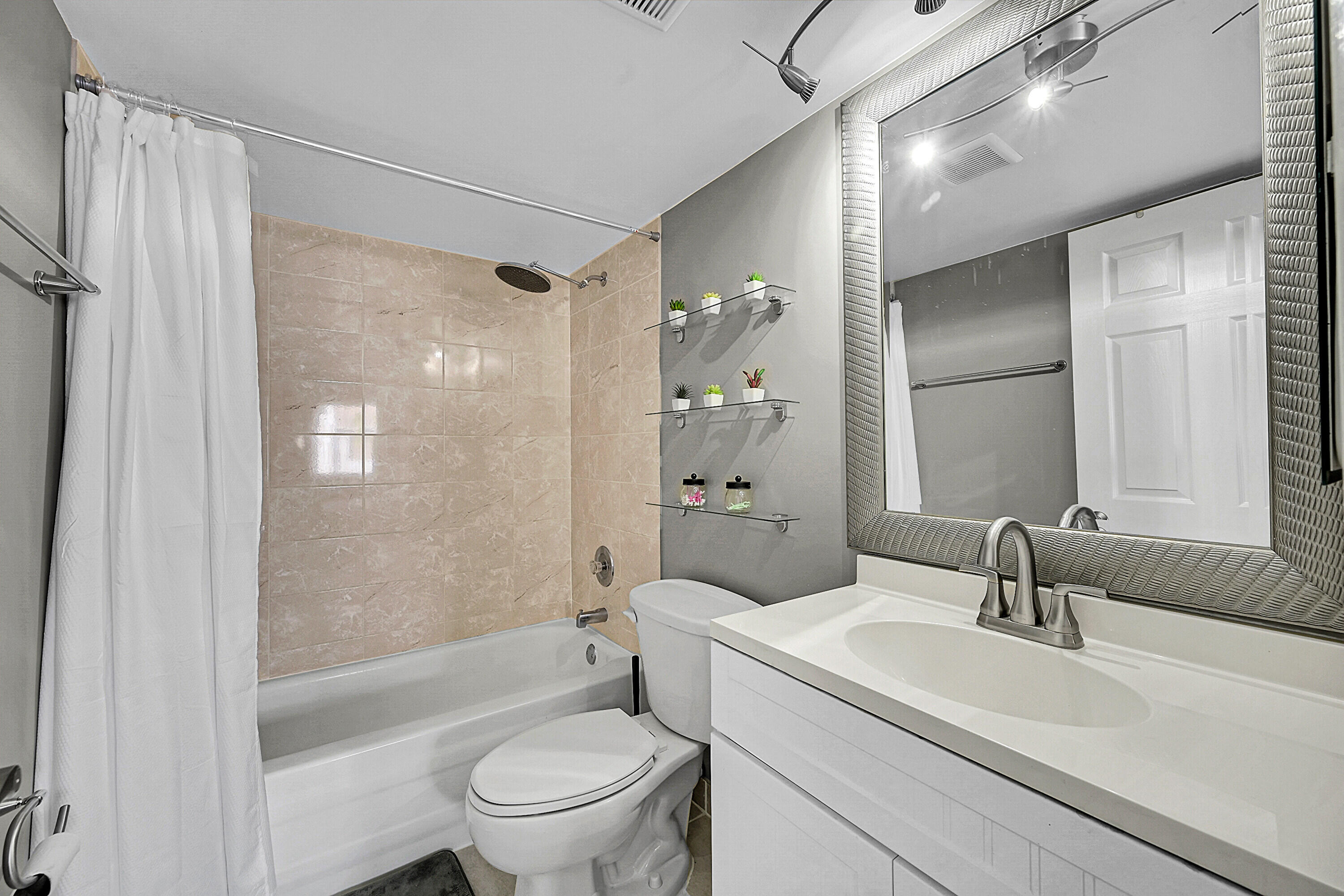 2920 Southwest 22nd Avenue, Unit 6040 Delray Beach, FL 33445 - Photo 23 of 53 a bathroom with a sink toilet a shower and a mirror