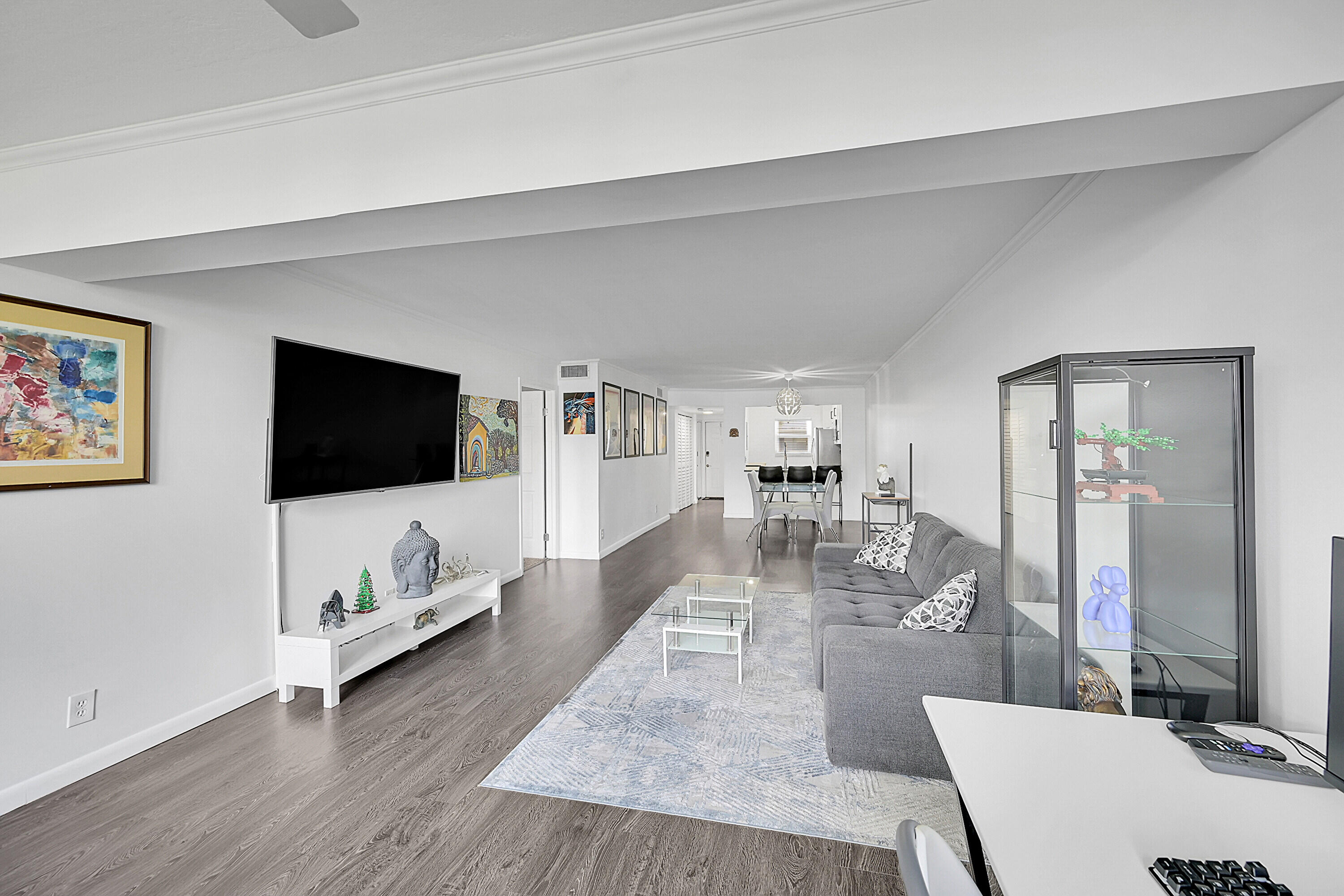 2920 Southwest 22nd Avenue, Unit 6040 Delray Beach, FL 33445 - Photo 29 of 53 a living room with furniture and a flat screen tv