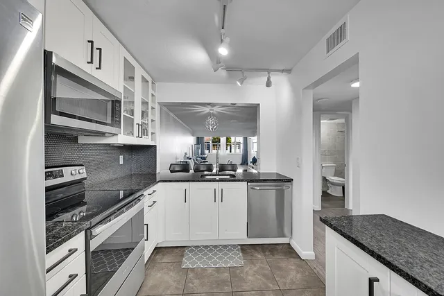 a kitchen with a table chairs and microwave