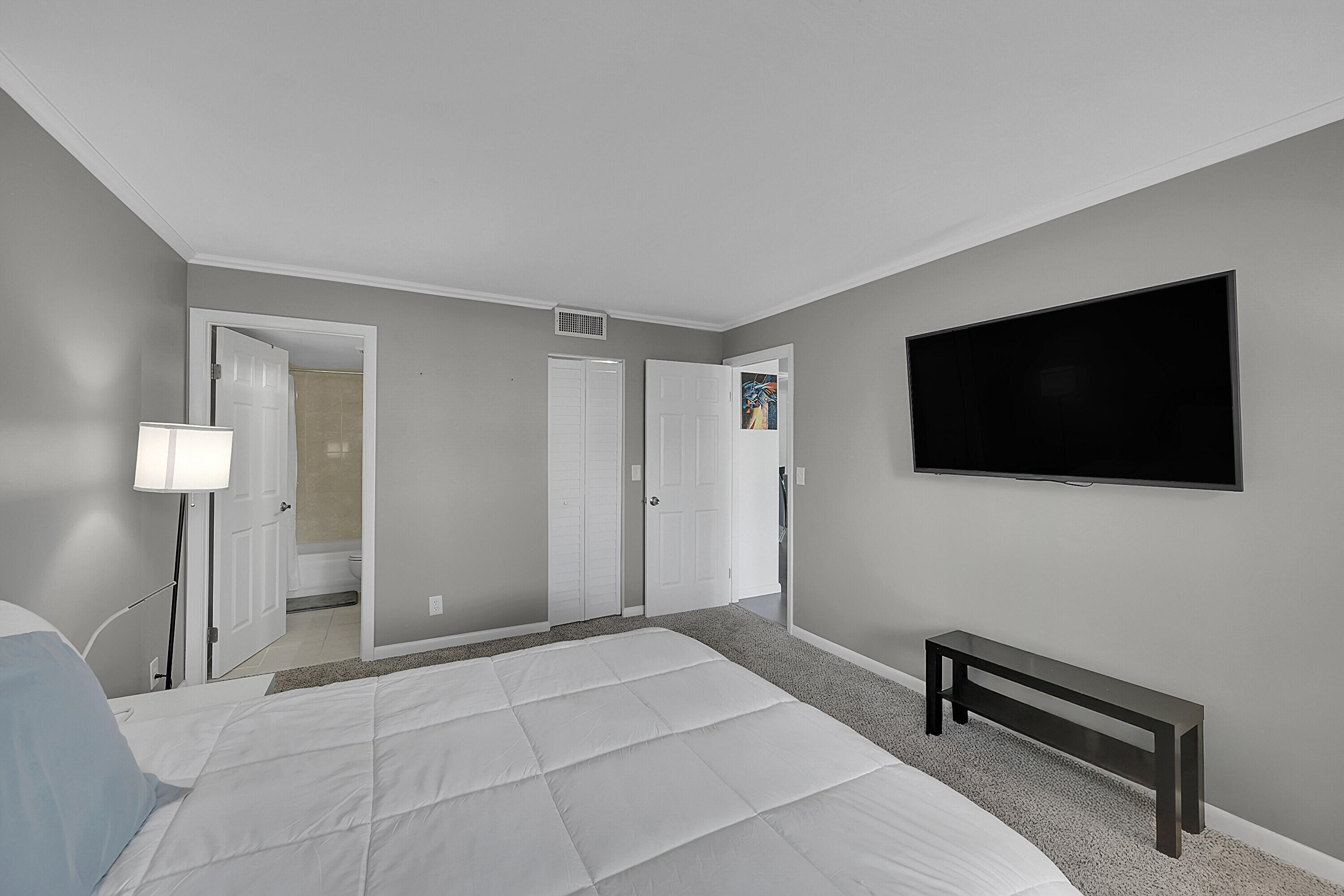 2920 Southwest 22nd Avenue, Unit 6040 Delray Beach, FL 33445 - Photo 35 of 53 a bedroom with a bed and a flat screen tv