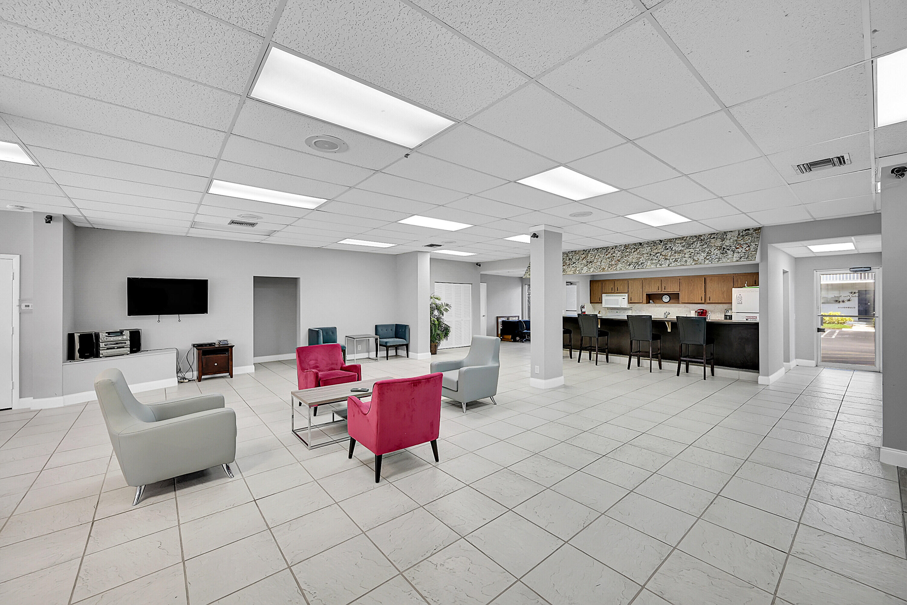 2920 Southwest 22nd Avenue, Unit 6040 Delray Beach, FL 33445 - Photo 39 of 53 a living room with furniture and a flat screen tv