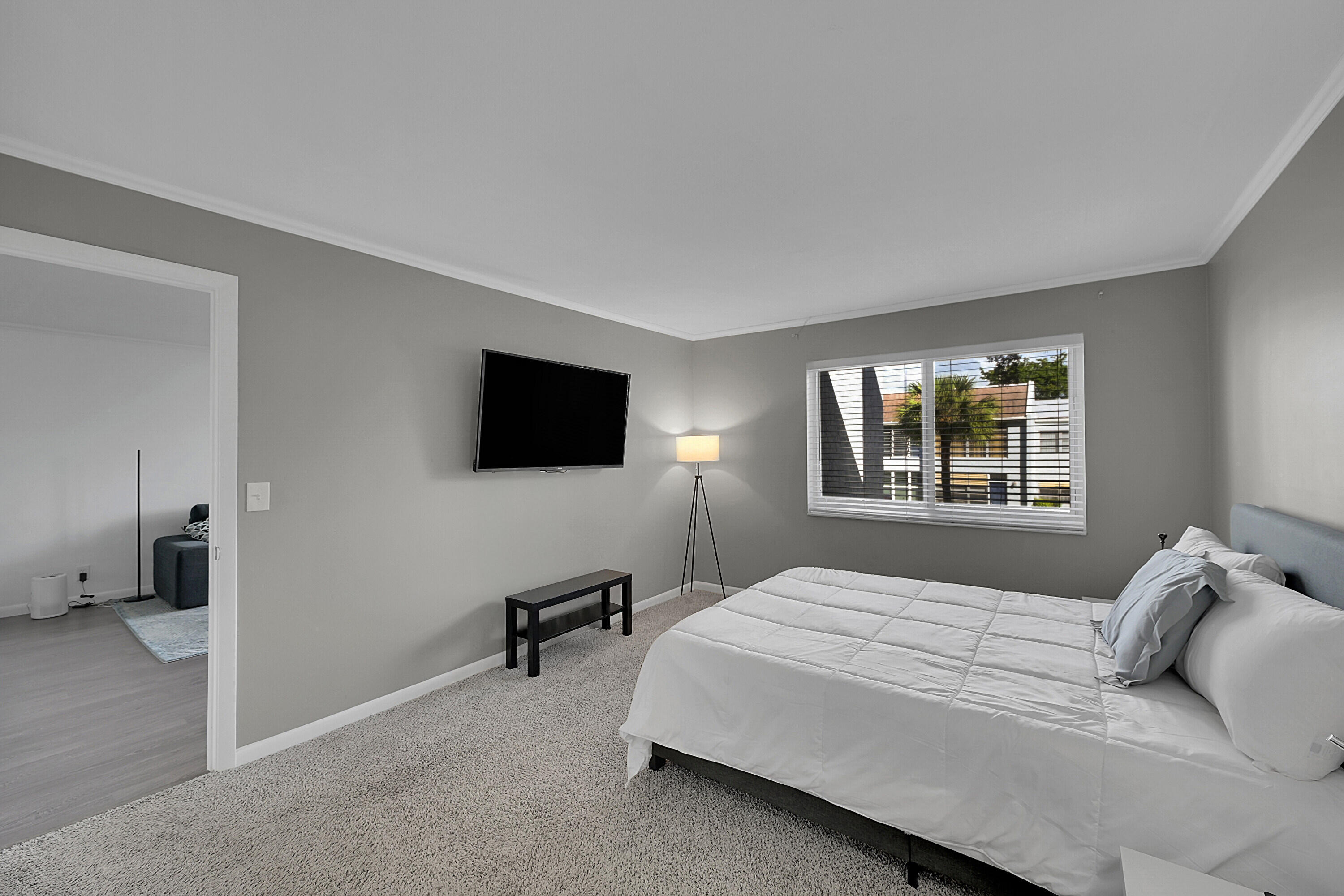 2920 Southwest 22nd Avenue, Unit 6040 Delray Beach, FL 33445 - Photo 41 of 53 a bedroom with a bed and a flat screen tv